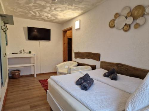 a bedroom with two beds and a tv on the wall at Zum Alten Schulhaus in Burg