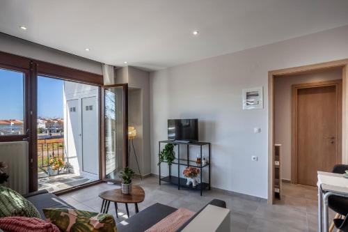 a living room with a couch and a tv at Lucid Dream Apt. |Bozinis in Psakoudia