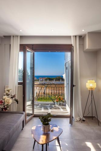 a living room with a couch and a large window at Lucid Dream Apt. |Bozinis in Psakoudia
