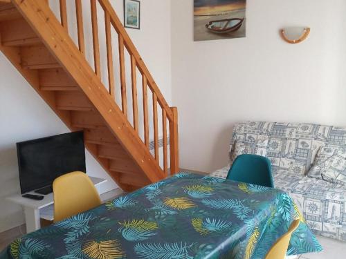 Cette chambre comprend un bureau avec un ordinateur et deux chaises. dans l'établissement Maison Vendéenne avec Piscine Privée, Proche Plages et Commerces - FR-1-476-27, à La Faute-sur-Mer