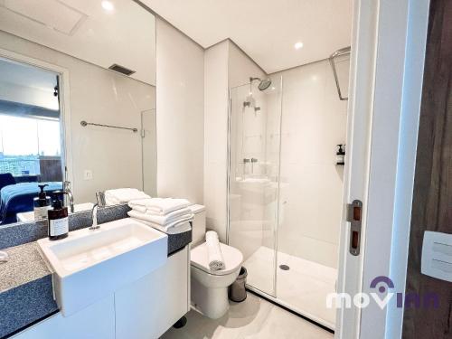 een badkamer met een douche, een wastafel en een toilet bij River One - Butantã in Sao Paulo