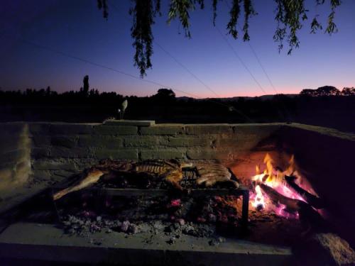 a fire burns in a brick fireplace at night at SANTA MARIA REINA in San Rafael