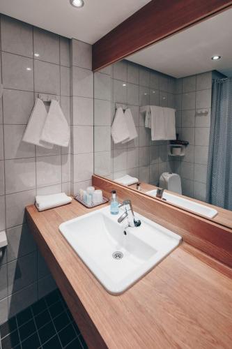 a bathroom with a sink and a mirror at Centro Hotel Turku in Turku