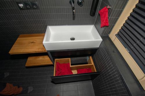a bathroom with a white sink and a wooden table at Kubus in Memmingen