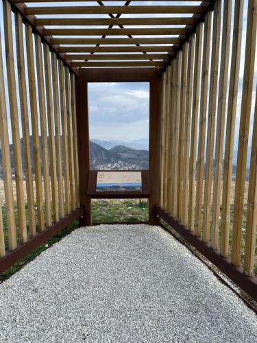 a view from the balcony of a building with a bench at Chalet Leonard House in the wood in Pennabilli