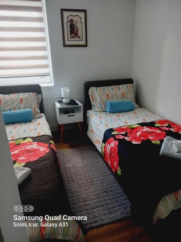a bedroom with two twin beds and a window at AUTOMOTODROM GROBNIK - Apartments and Rooms Skejić in Čavle
