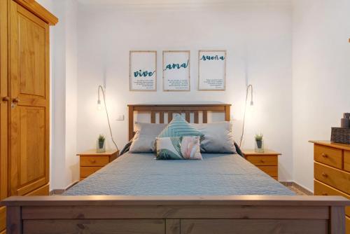 a bedroom with a bed with blue sheets and pillows at Casa Turquesa in Tamaraceite