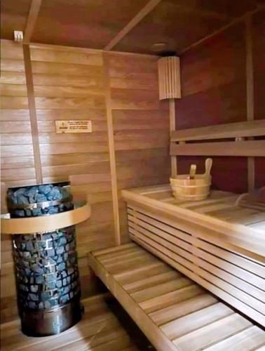 a room with a sauna with a stack of logs at Luxury Suites at Brenthill Baguio City in Baguio