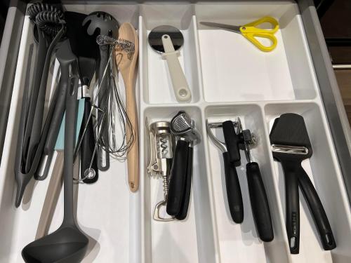 a white drawer filled with kitchen utensils at Notodden Sentrum Apartment NO 11 in Notodden