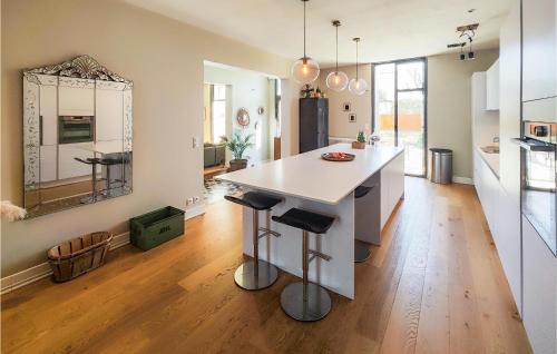 a kitchen with a white island in the middle of a room at Cozy Home In Valros With Wifi in Valros