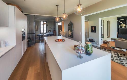 a kitchen with a large white island in a room at Cozy Home In Valros With Wifi in Valros