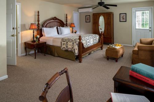 a bedroom with a large bed and a couch at The Yellow House on Plott Creek in Waynesville