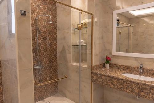 a bathroom with a shower and a sink at Adam's Luxury Villa DeadSea in Sowayma