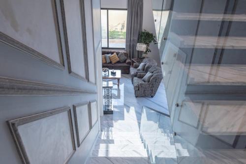 an overhead view of a living room with a couch and chairs at Adam's Luxury Villa DeadSea in Sowayma