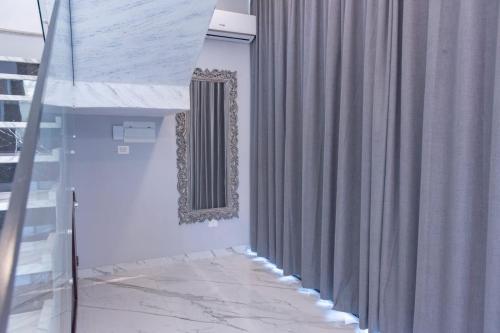 a room with a shower curtain and a stair case at Adam's Luxury Villa DeadSea in Sowayma