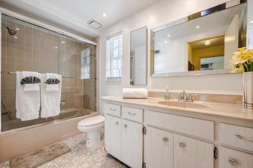 a bathroom with a sink and a shower and a toilet at Heated Saltwater Pool, Sleeps 6 - Villa Shangri-La in Cape Coral