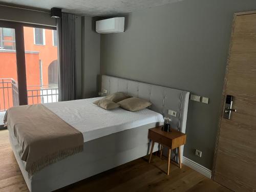 a bedroom with a bed and a table with a window at Art Apartments in Berlin