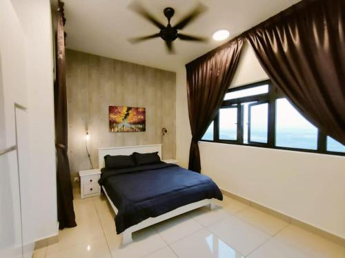 a bedroom with a bed and a ceiling fan at Meridin Medini, Iskandar Puteri, Johor in Nusajaya