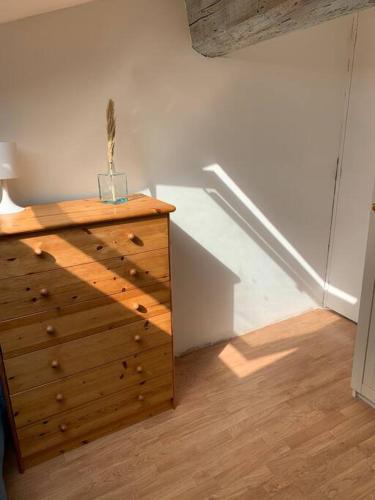 a wooden dresser in a room with a staircase at AGDE HOLIDAYS in Agde