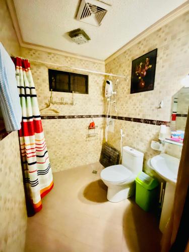 a bathroom with a toilet and a sink at Panabo Furnished house-Downstairs in Panabo