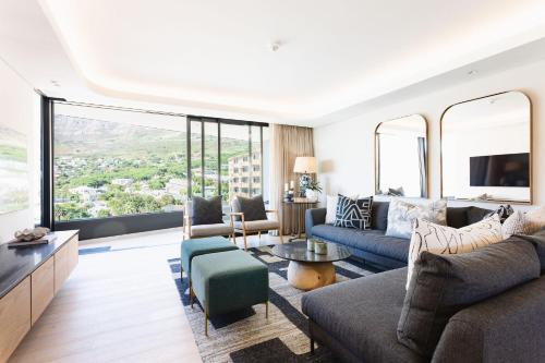 a living room with a couch and a tv at The View - Brand new Penthouse with private rooftop pool in Cape Town