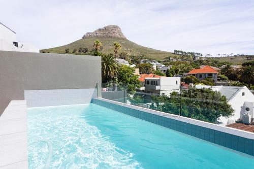 a pool on the roof of a house with a mountain in the background at The View - Brand new Penthouse with private rooftop pool in Cape Town