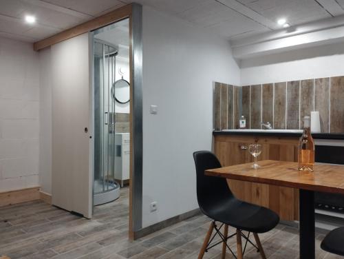 a dining room with a table and a mirror at Best Price #1 "L'ANN'EXE" x4 people in Orchamps-Vennes