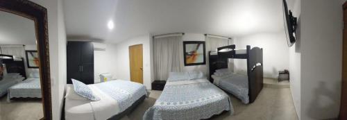 Hotel Riviera Plaza في بوكارامانغا: غرفة نوم بسريرين ومرآة