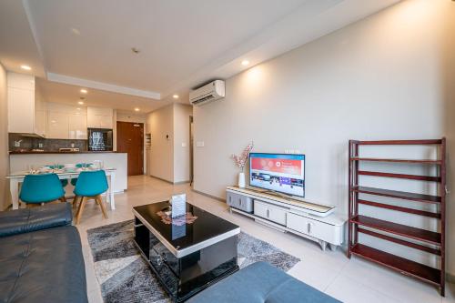a living room with a couch and a flat screen tv at Cozy Apartment in District 4-City Center - Free Netflix - canhogiatot24h in Ho Chi Minh City