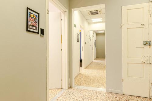 a hallway with a white door and a hallway with a hallway at Game Rooms Experience in Livorno