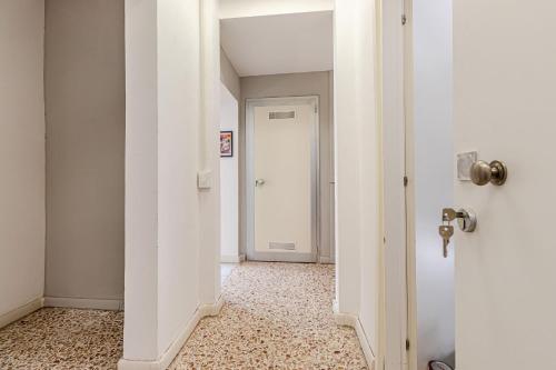 an empty hallway with a white door and a room at Game Rooms Experience in Livorno