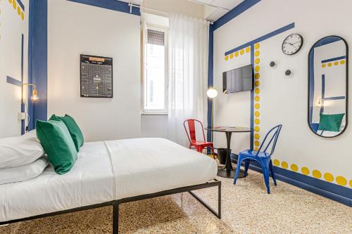 a bedroom with a bed and a table and chairs at Game Rooms Experience in Livorno