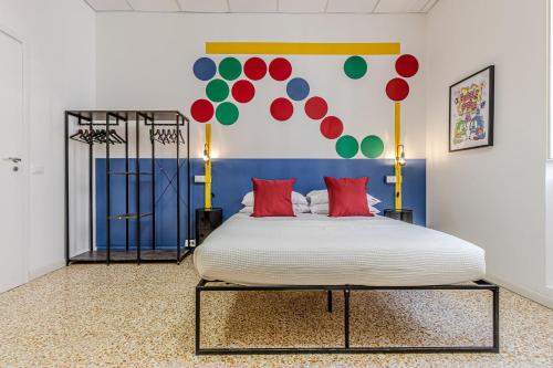 a bedroom with a large bed with red pillows at Game Rooms Experience in Livorno