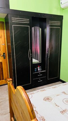 a room with two black cabinets and a chair at Ramya’s Villa in Trincomalee