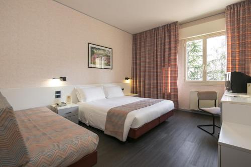 Кровать или кровати в номере Hotel Falco D'Oro