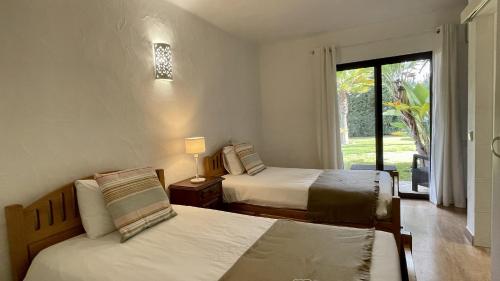 A bed or beds in a room at Golfinho by Check-in Portugal