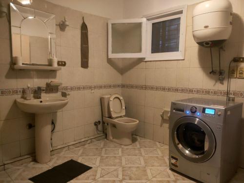 a bathroom with a washing machine and a toilet at القاهره in Cairo