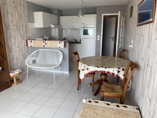 a kitchen with a table and a table and chairs at Appartement T2 neuf avec parking à Fort-Mahon-Plage - FR-1-482-77 in Fort-Mahon-Plage