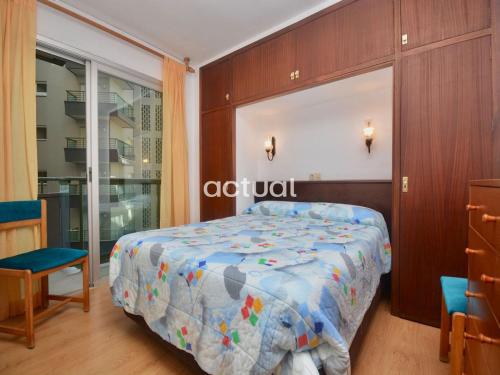 a bedroom with a bed with a colorful comforter at Fanals 5B in Platja d'Aro