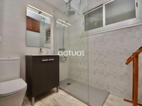 a bathroom with a toilet and a glass shower at Fanals 5B in Platja d'Aro