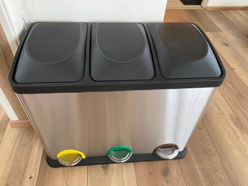 a metal trash can with a black top at Álftártunga Farm Guesthouse in Borgarnes