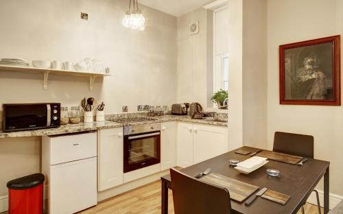 a kitchen with a table and a dining room at Ludwick Apartment in Shrewsbury