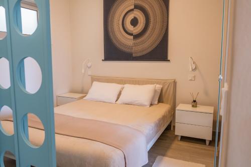 a bedroom with a bed and a picture on the wall at Mythical Spa Suite - GYM*Yoga Room*Pools in Protaras