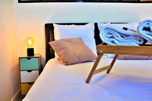a bed with white sheets and a pillow on it at Le Central Rhône 2 - vue grandiose - in Lyon