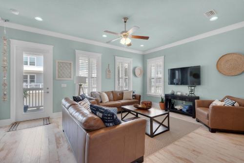 a living room with two couches and a tv at Dream Maker in Navarre