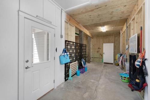 a hallway with a white door and wooden walls at Dream Maker in Navarre