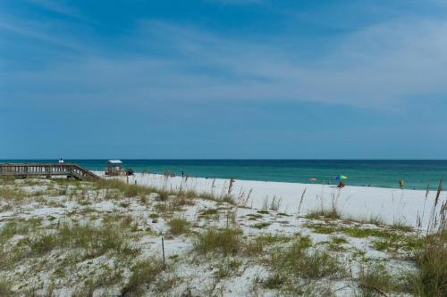 a beach with people on the sand and the ocean at Dream Maker in Navarre