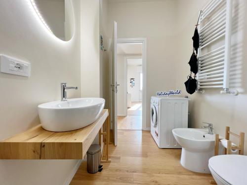 a bathroom with a sink and two toilets at Seaside Luxury Apartment by Holiday World in Cogoleto