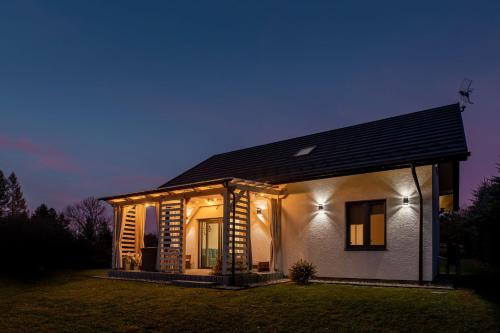 a small house with lights on it at night at Bieszczadzkie Niebo in Stefkowa