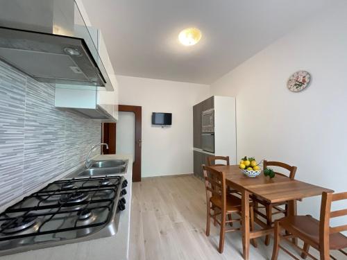 a kitchen with a table and a stove top oven at CASA ROSELLINA SORRENTO in Sorrento